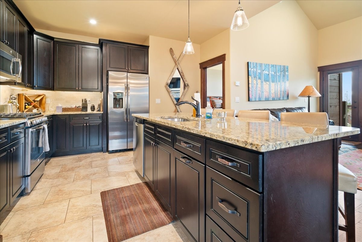 853 Independence Road, Unit 853 Keystone, CO 80435 - Photo 13 of 37 a kitchen with stainless steel appliances granite countertop a sink stove and refrigerator
