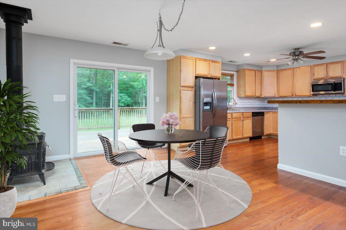 1232 Perrys Corner Road Grasonville, MD 21638 - Photo 9 of 35 Dining area & wood stove just off the kitchen