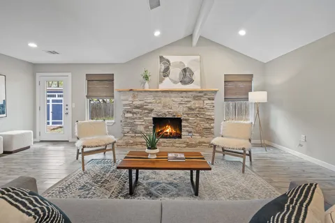 a living room with furniture and a fireplace