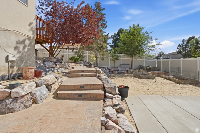 926 Ibis Way Draper, UT 84020 - Photo 33 of 41 More rockwork with colored, stamped concrete stairs with lighting.