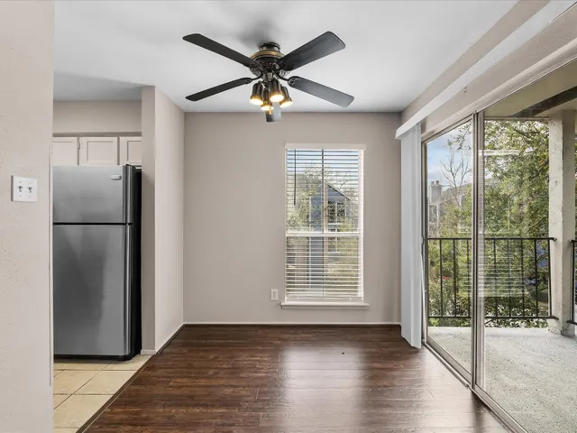 wooden floor in an empty room with a kitchen