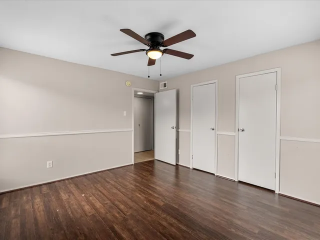 a bathroom with a granite countertop sink a toilet a mirror and shower