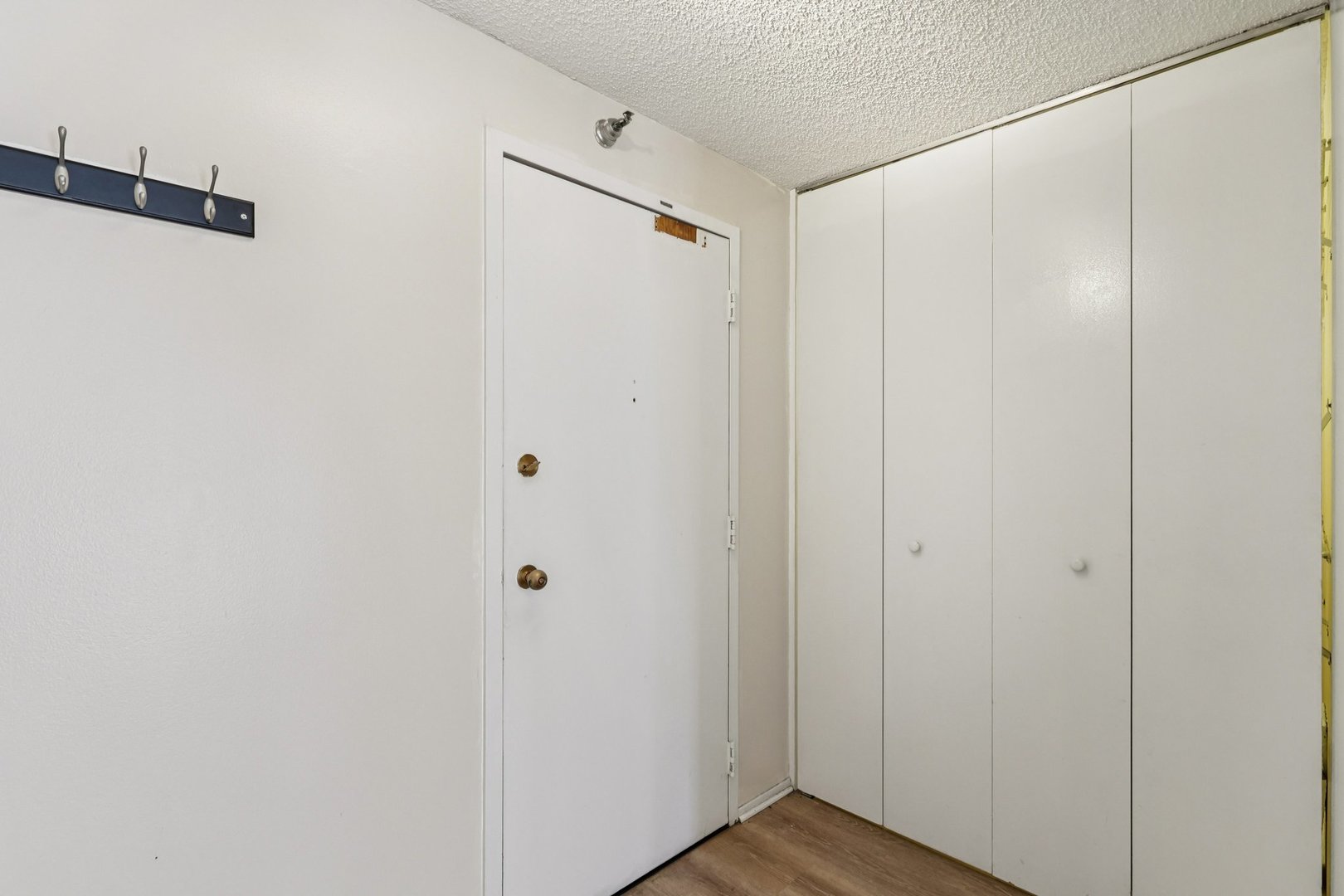 70 West Huron Street, Unit 2210 Chicago, IL 60654 - Photo 4 of 18 a view of a hallway with wooden floor