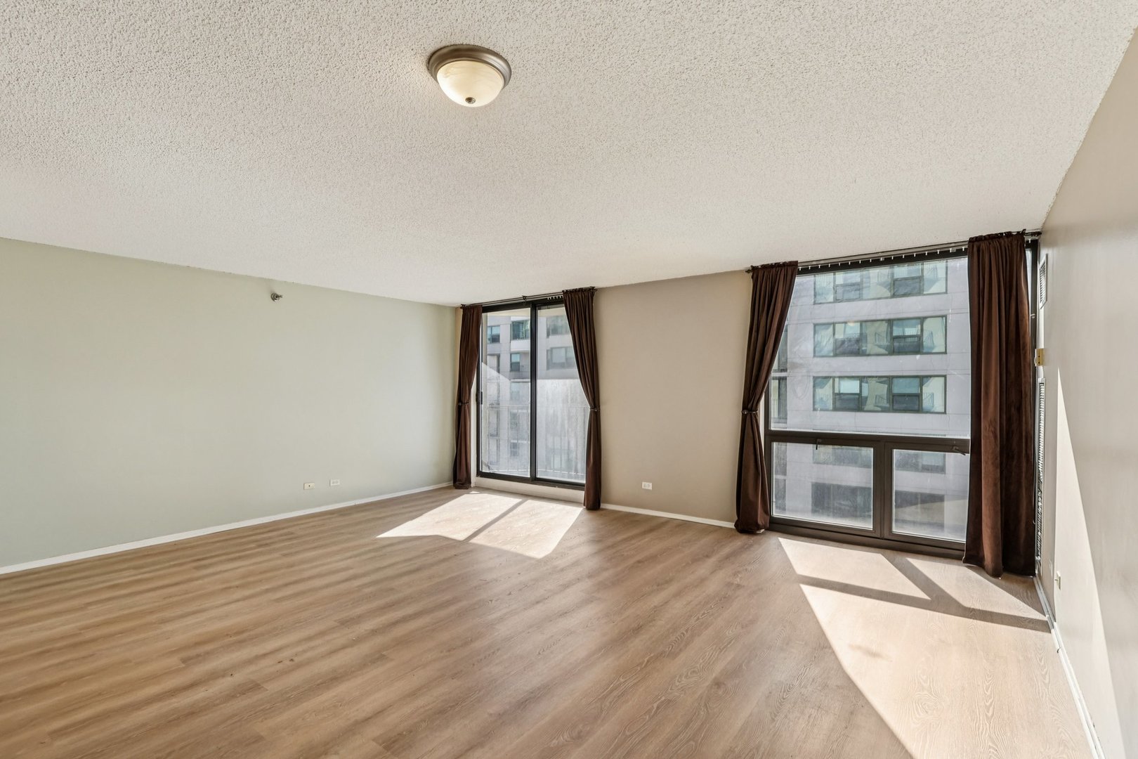 70 West Huron Street, Unit 2210 Chicago, IL 60654 - Photo 6 of 18 wooden floor in an empty room with a window