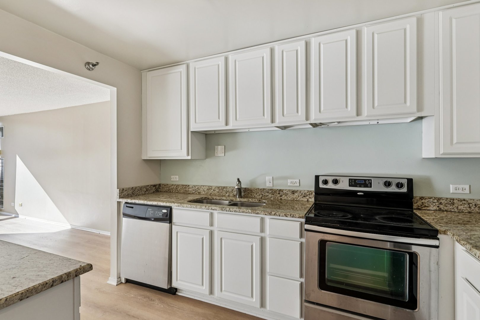 70 West Huron Street, Unit 2210 Chicago, IL 60654 - Photo 9 of 18 a kitchen with granite countertop white cabinets and a stove