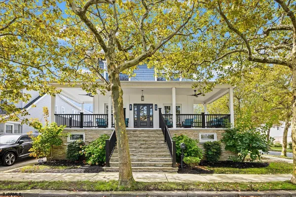 front view of a house with a tree in front
