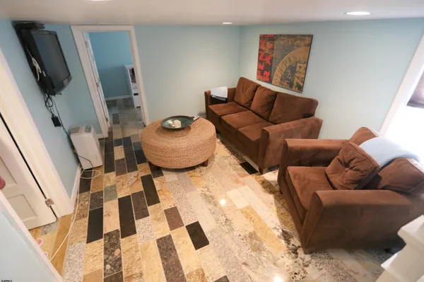 a living room with furniture and a rug