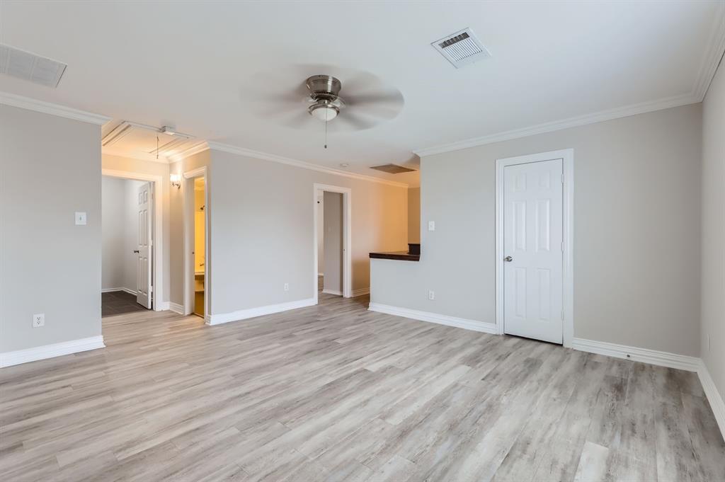 1406 Buckingham Drive Forney, TX 75126 - Photo 14 of 30 a view of empty room with wooden floor and ceiling fan