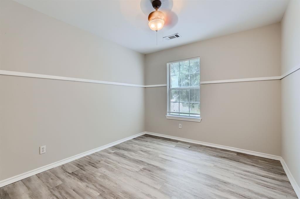 1406 Buckingham Drive Forney, TX 75126 - Photo 18 of 30 a view of an empty room with wooden floor and a window
