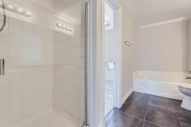 a bathroom with a granite countertop sink mirror and a bathtub