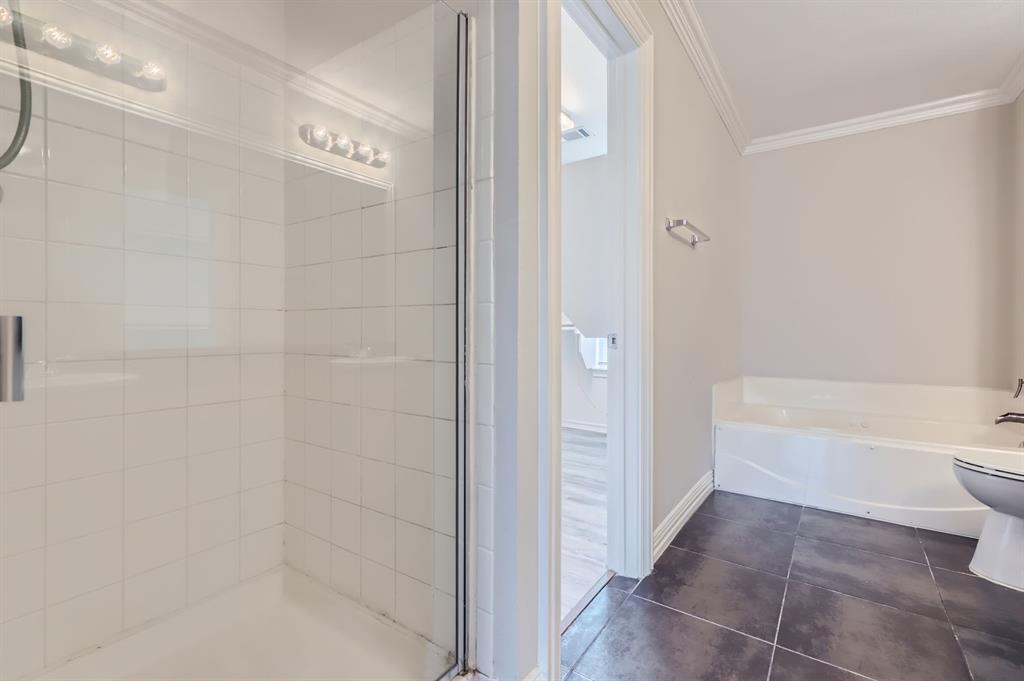 1406 Buckingham Drive Forney, TX 75126 - Photo 19 of 30 a bathroom with a bathtub and toilet