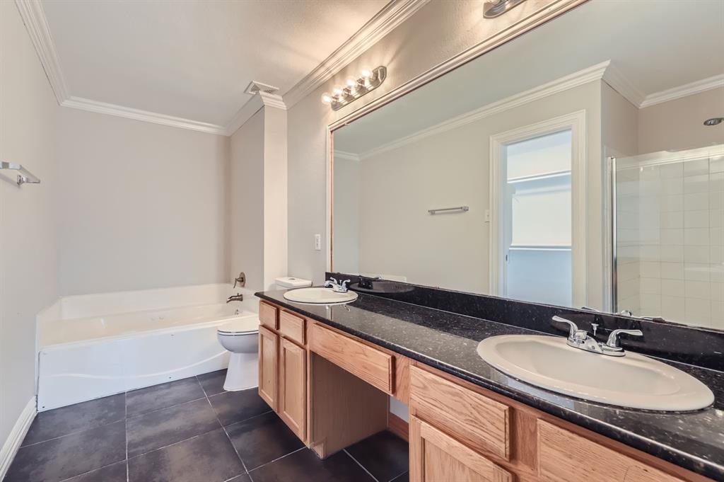 1406 Buckingham Drive Forney, TX 75126 - Photo 20 of 30 a bathroom with a granite countertop sink mirror and a bathtub
