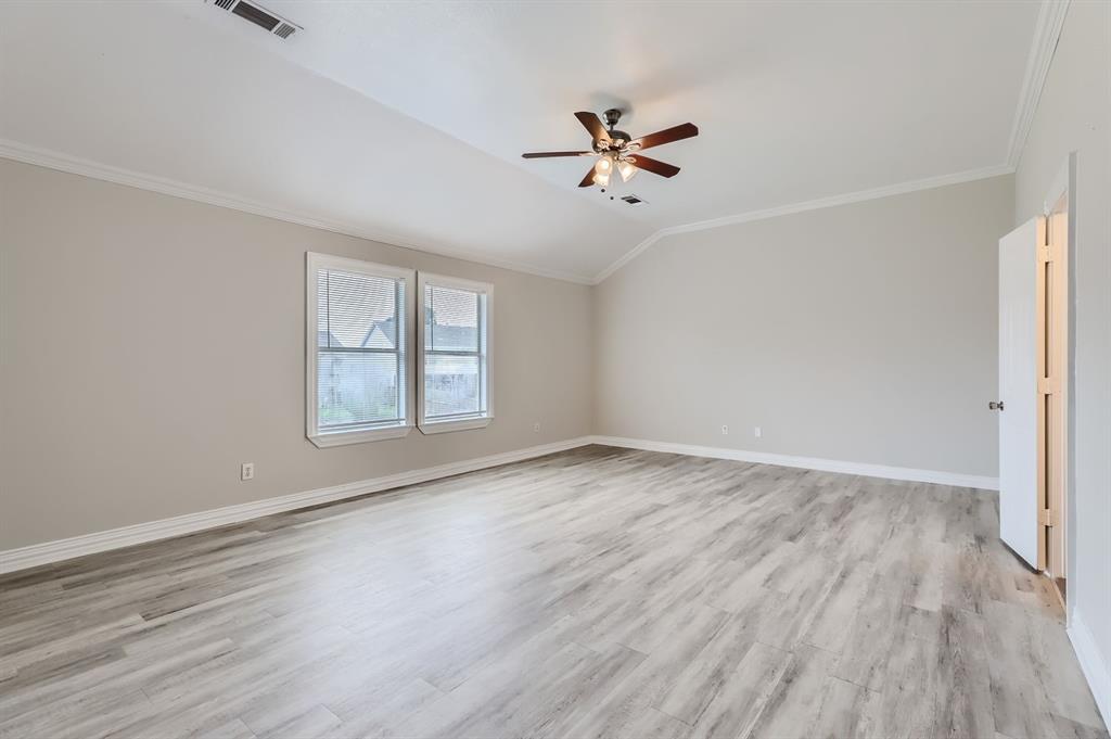 1406 Buckingham Drive Forney, TX 75126 - Photo 22 of 30 a view of empty room with wooden floor and fan