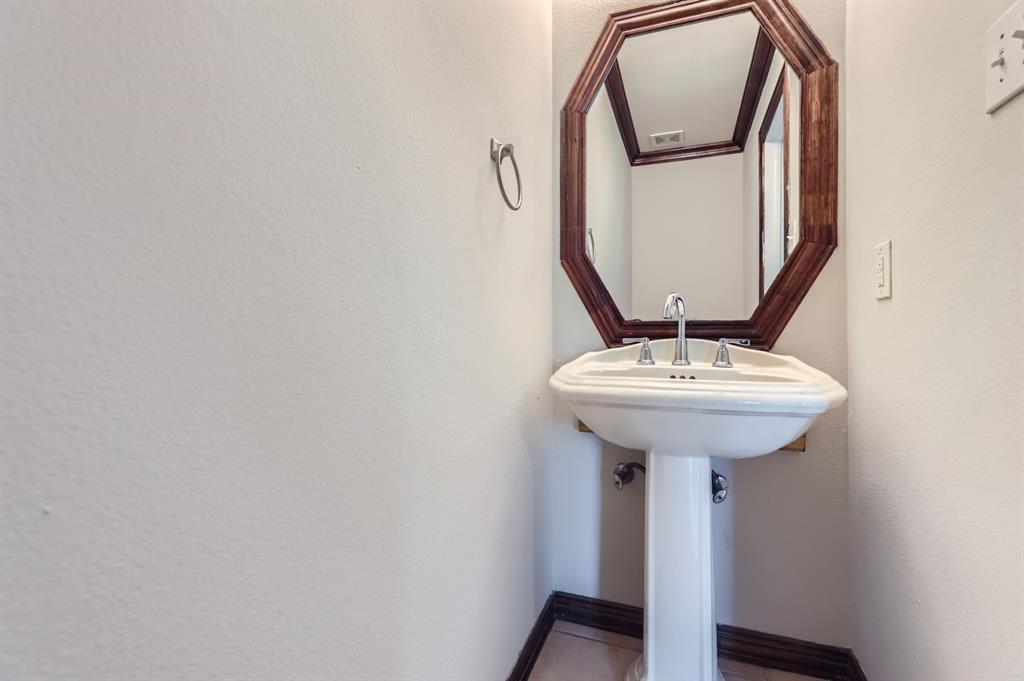 1406 Buckingham Drive Forney, TX 75126 - Photo 23 of 30 a bathroom with a sink and a mirror