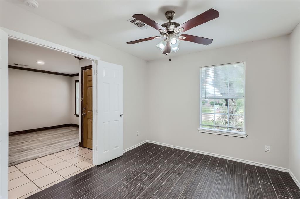 1406 Buckingham Drive Forney, TX 75126 - Photo 4 of 30 a view of an empty room with wooden floor and a window