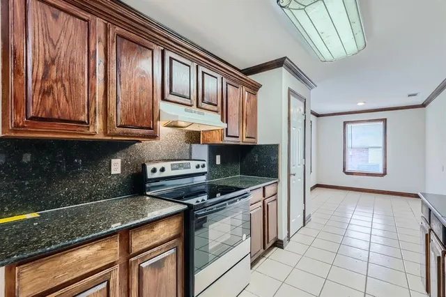 a kitchen with stainless steel appliances granite countertop a sink stove and cabinets