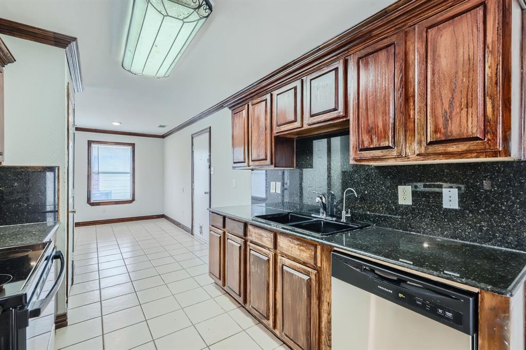1406 Buckingham Drive Forney, TX 75126 - Photo 9 of 30 a kitchen with stainless steel appliances granite countertop a sink stove and cabinets