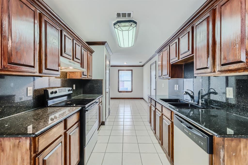 1406 Buckingham Drive Forney, TX 75126 - Photo 10 of 30 a kitchen with stainless steel appliances granite countertop a sink stove and cabinets