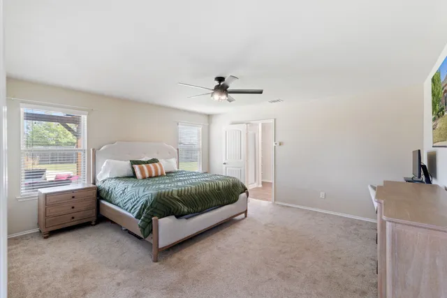 a spacious bedroom with a bed and a window