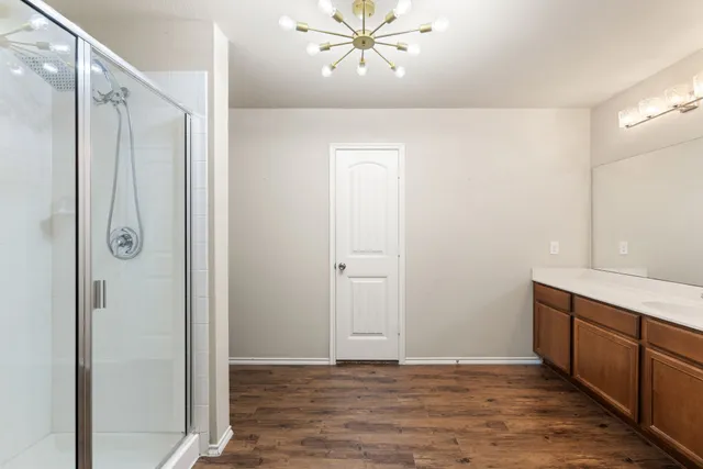a view of an empty room and wooden floor