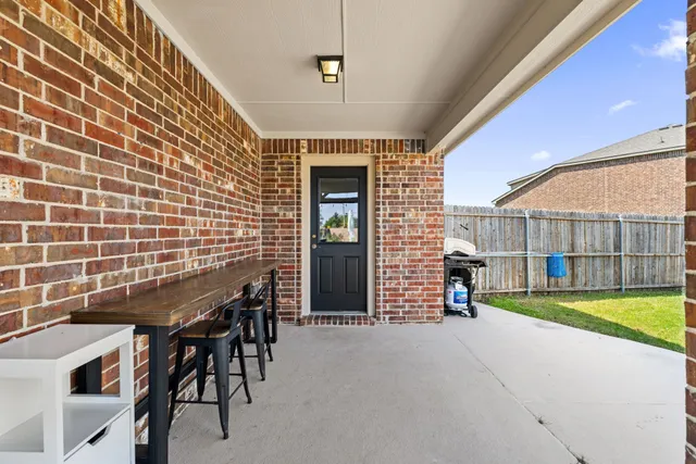 a view of an chairs and table in the patio