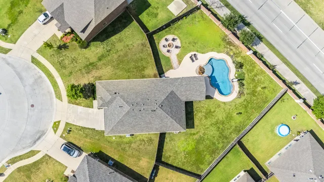 an aerial view of a house with a swimming pool