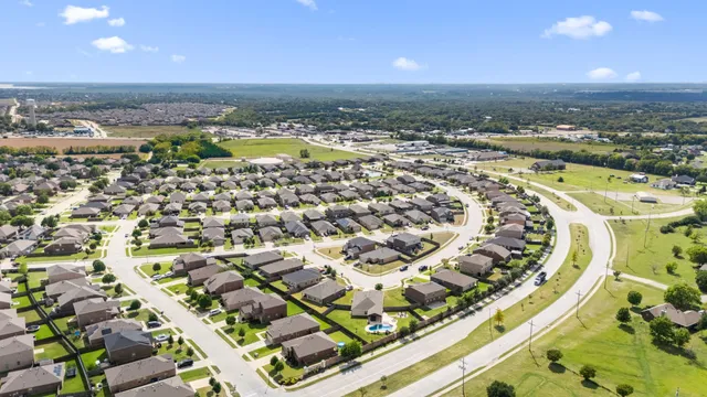 an aerial view of residential houses with outdoor space and swimming pool