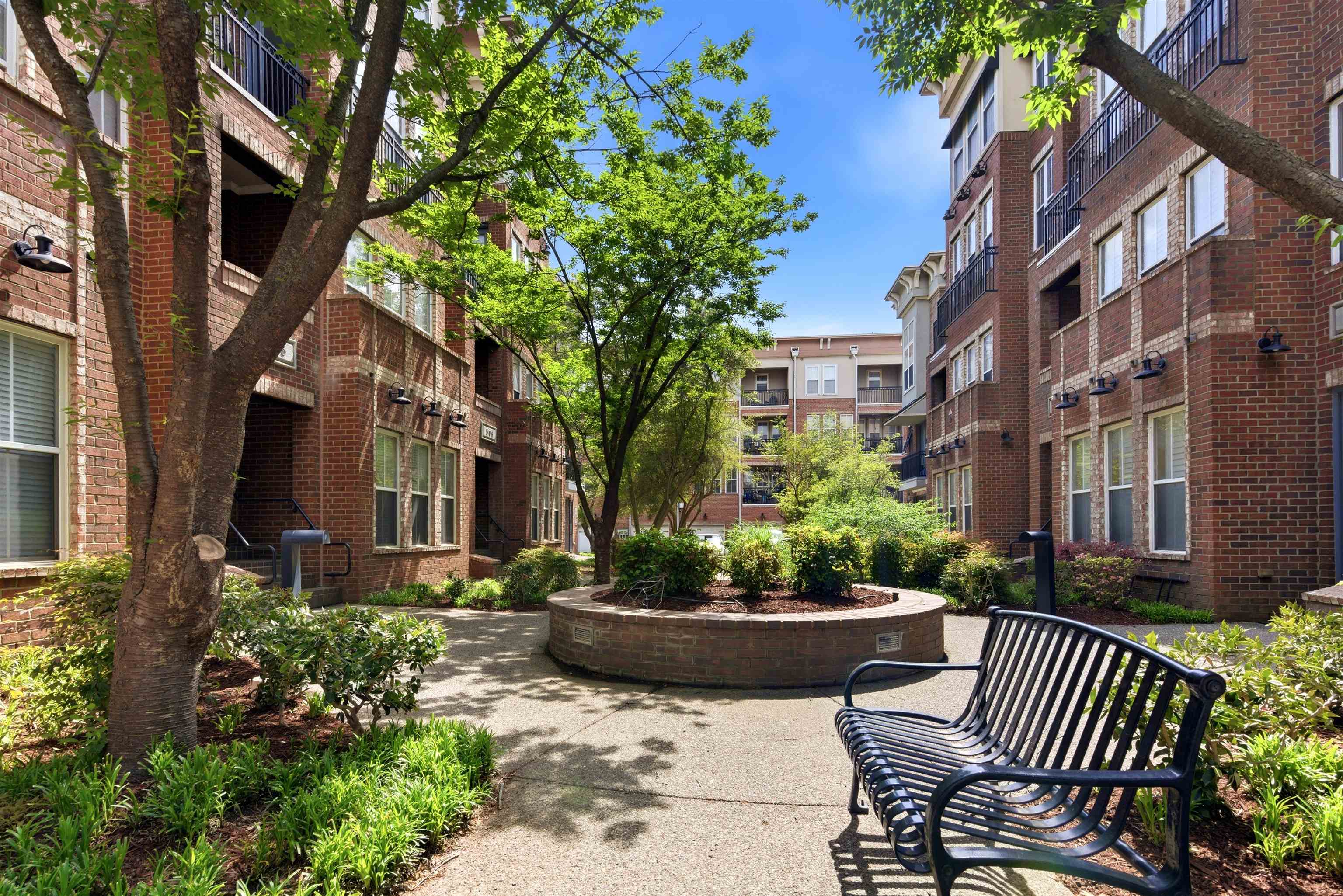 a view of a patio filled with furniture and a garden