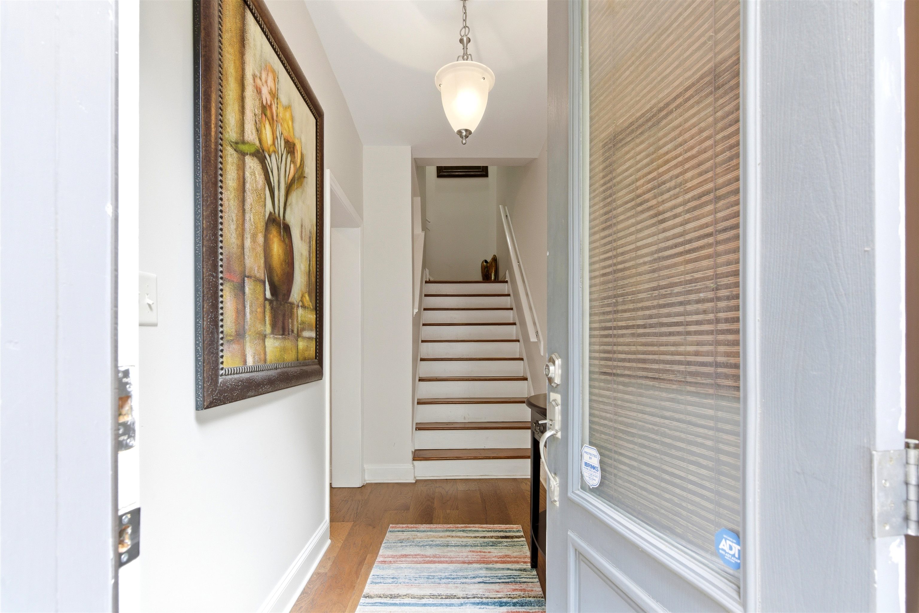 75 Shoemaker Court, Unit 105 Memphis, TN 38103 - Photo 13 of 36 a view of a hallway with wooden floor and staircase