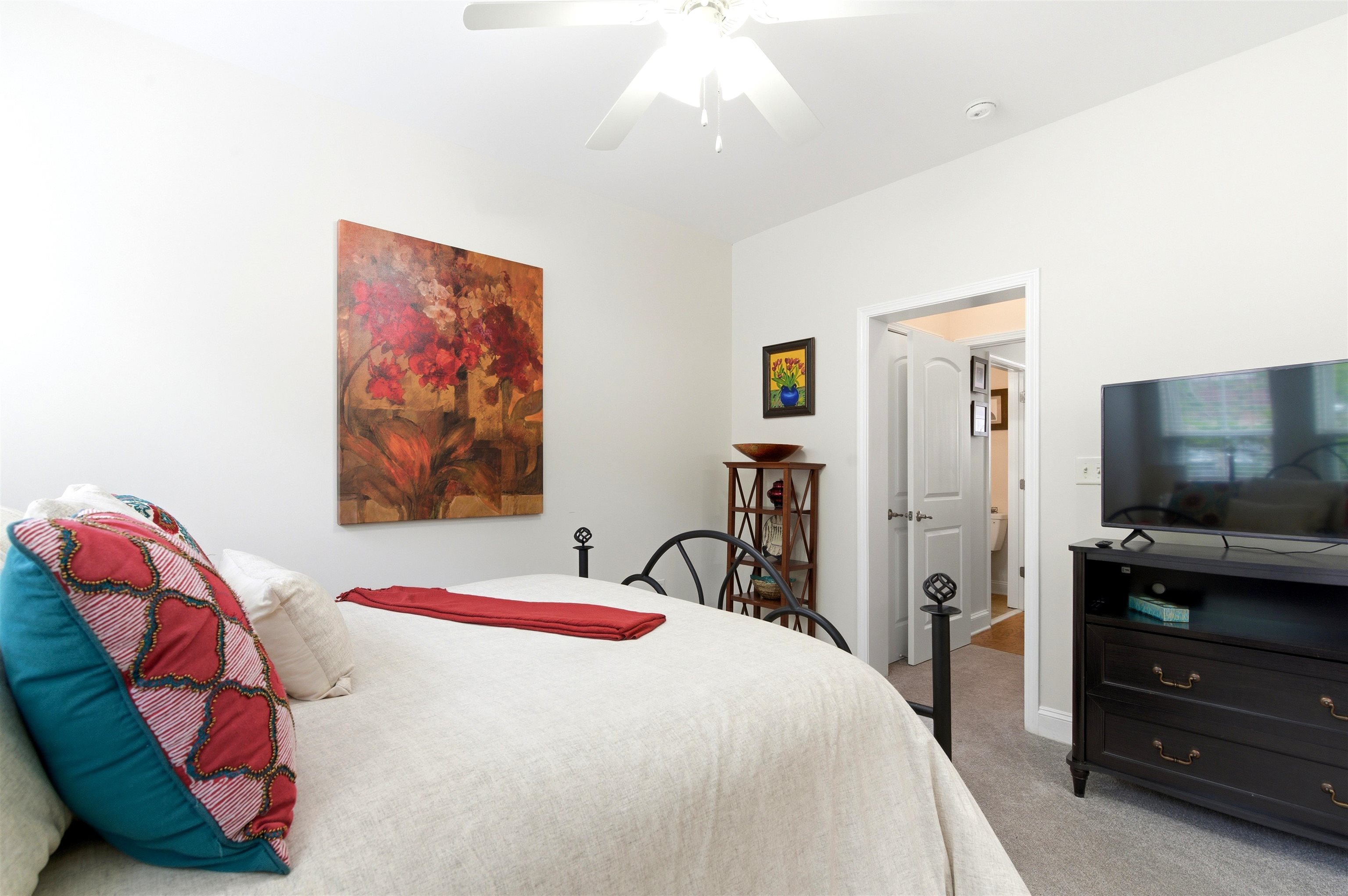 75 Shoemaker Court, Unit 105 Memphis, TN 38103 - Photo 19 of 36 a bedroom with a bed and a flat screen tv