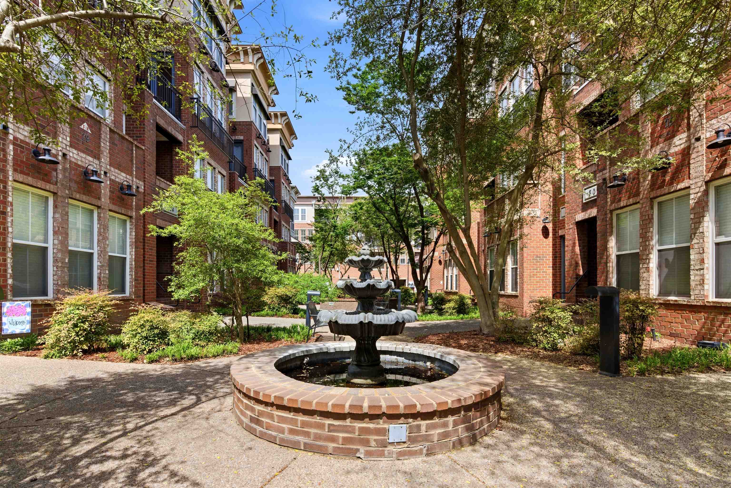 75 Shoemaker Court, Unit 105 Memphis, TN 38103 - Photo 2 of 36 a swimming pool with outdoor seating and plants