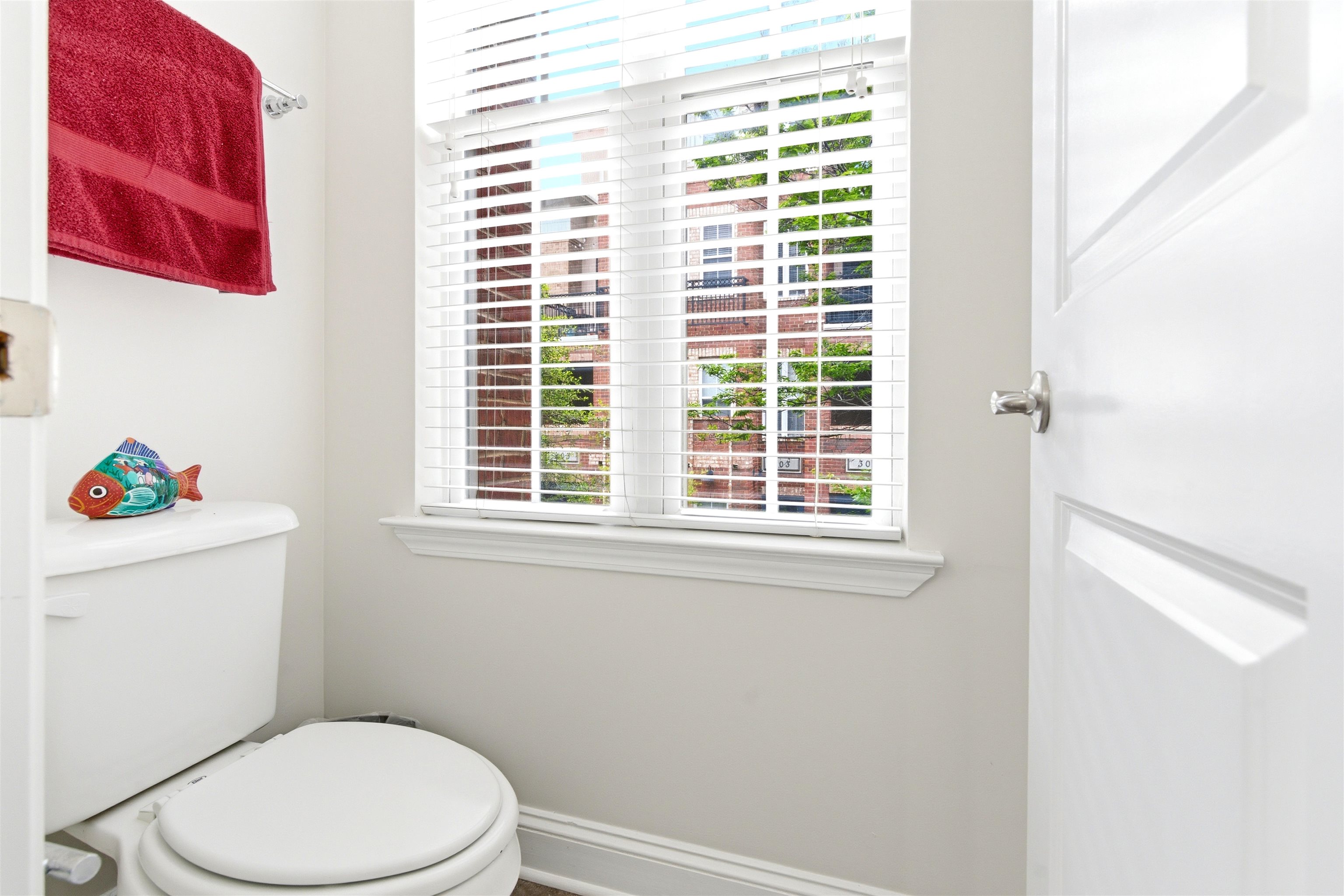 75 Shoemaker Court, Unit 105 Memphis, TN 38103 - Photo 21 of 36 a white toilet sitting next to a window