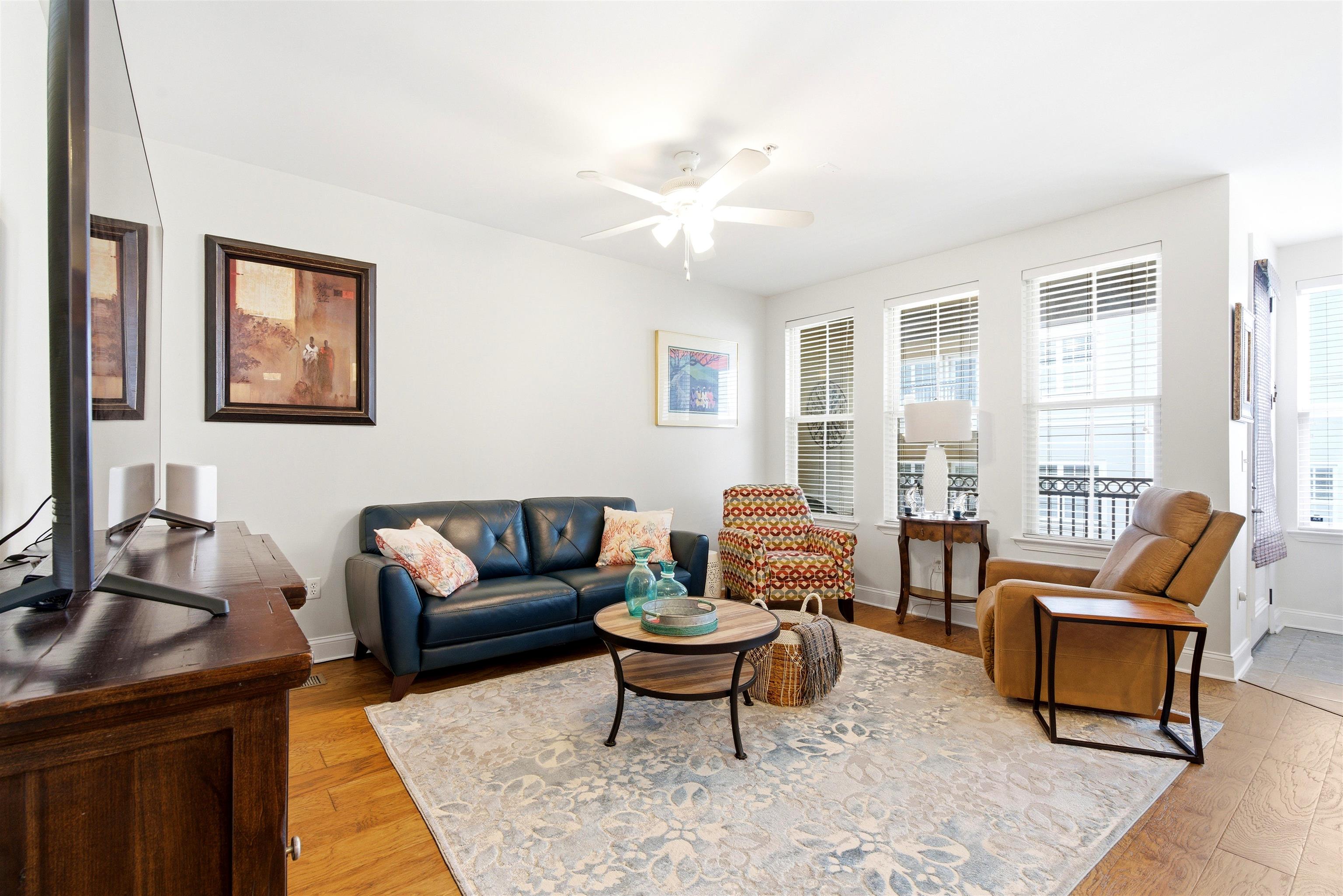 75 Shoemaker Court, Unit 105 Memphis, TN 38103 - Photo 23 of 36 a living room with furniture a rug and a large window