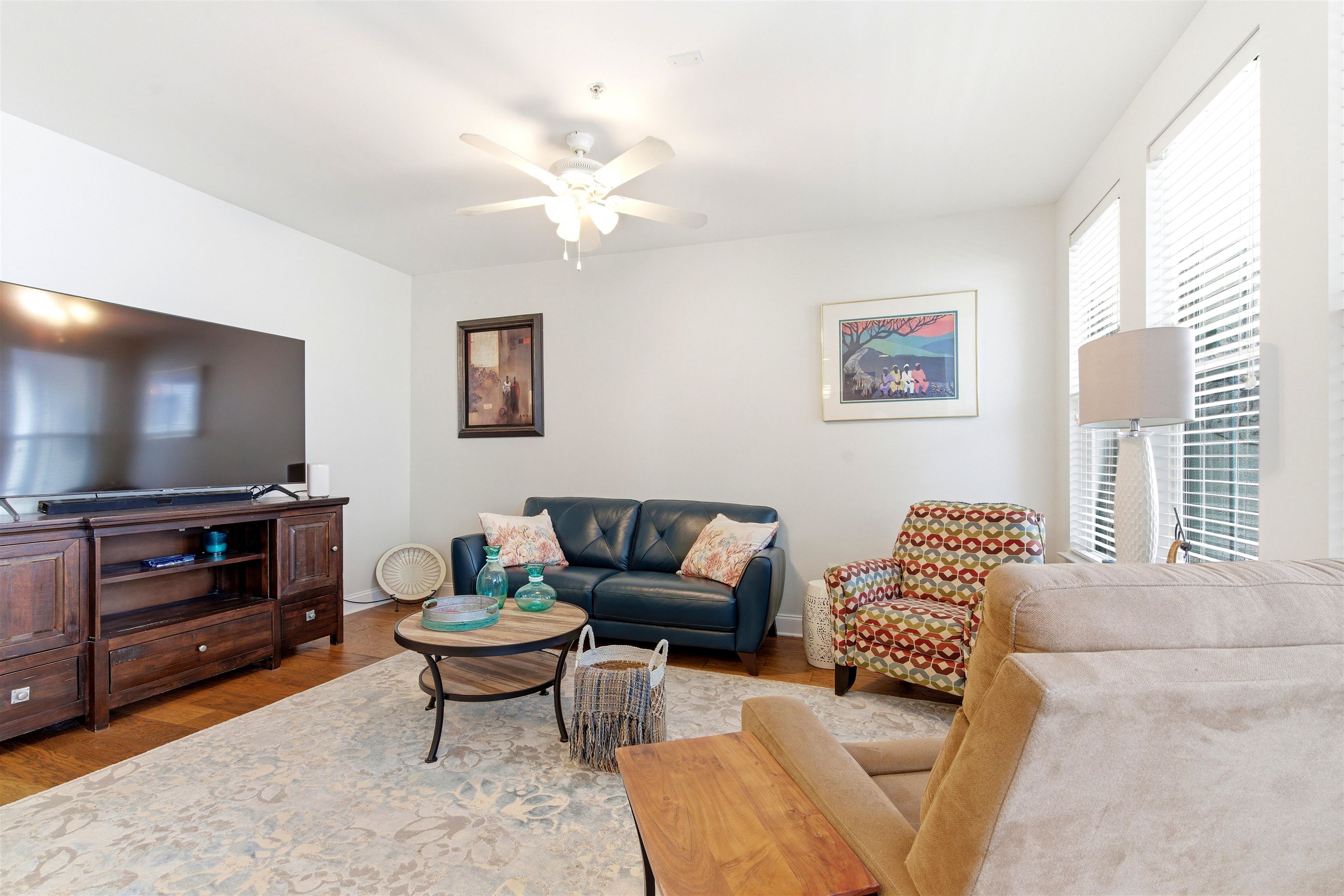 75 Shoemaker Court, Unit 105 Memphis, TN 38103 - Photo 24 of 36 a living room with furniture a flat screen tv and a window