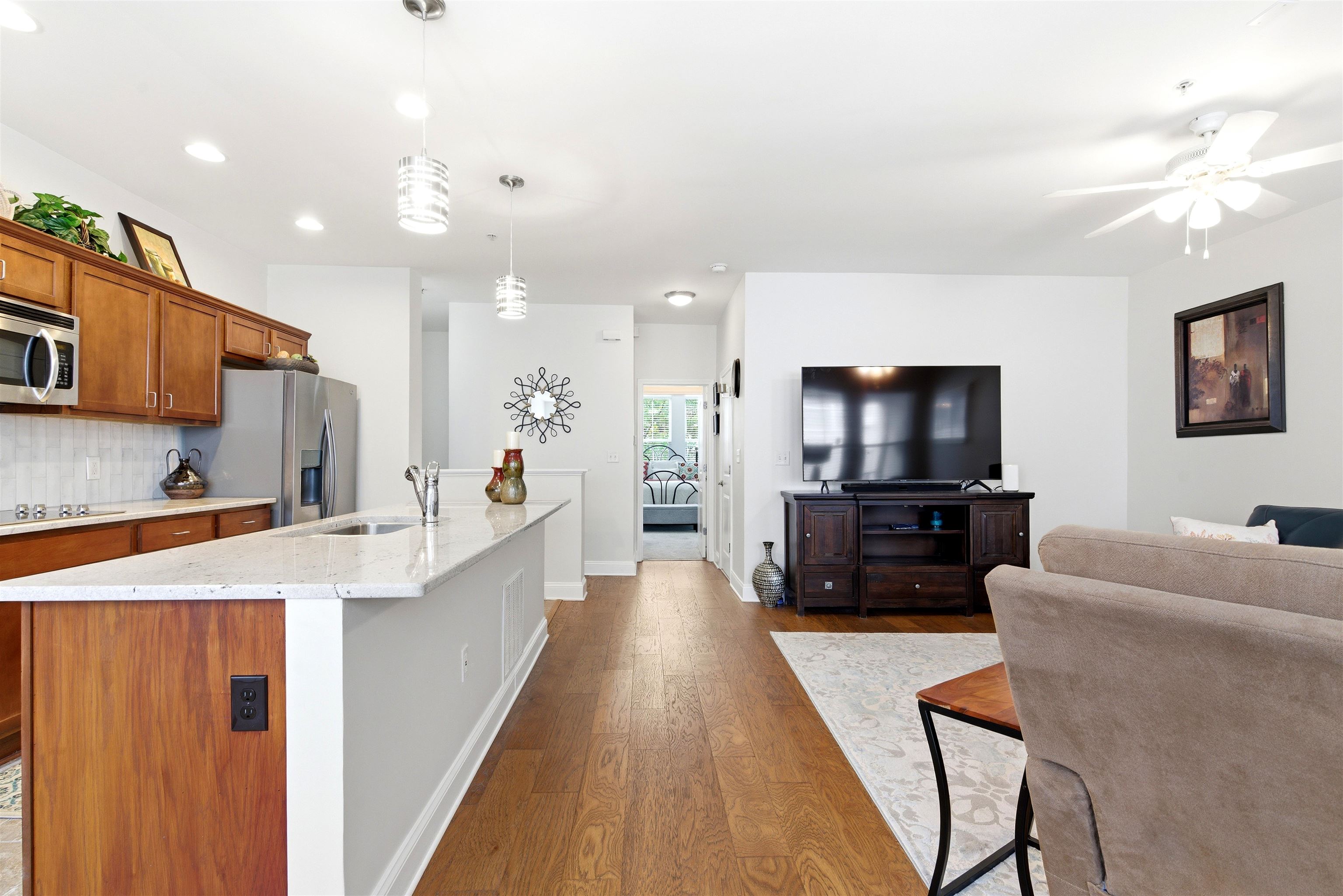75 Shoemaker Court, Unit 105 Memphis, TN 38103 - Photo 25 of 36 a living room with stainless steel appliances furniture a flat screen tv and kitchen view