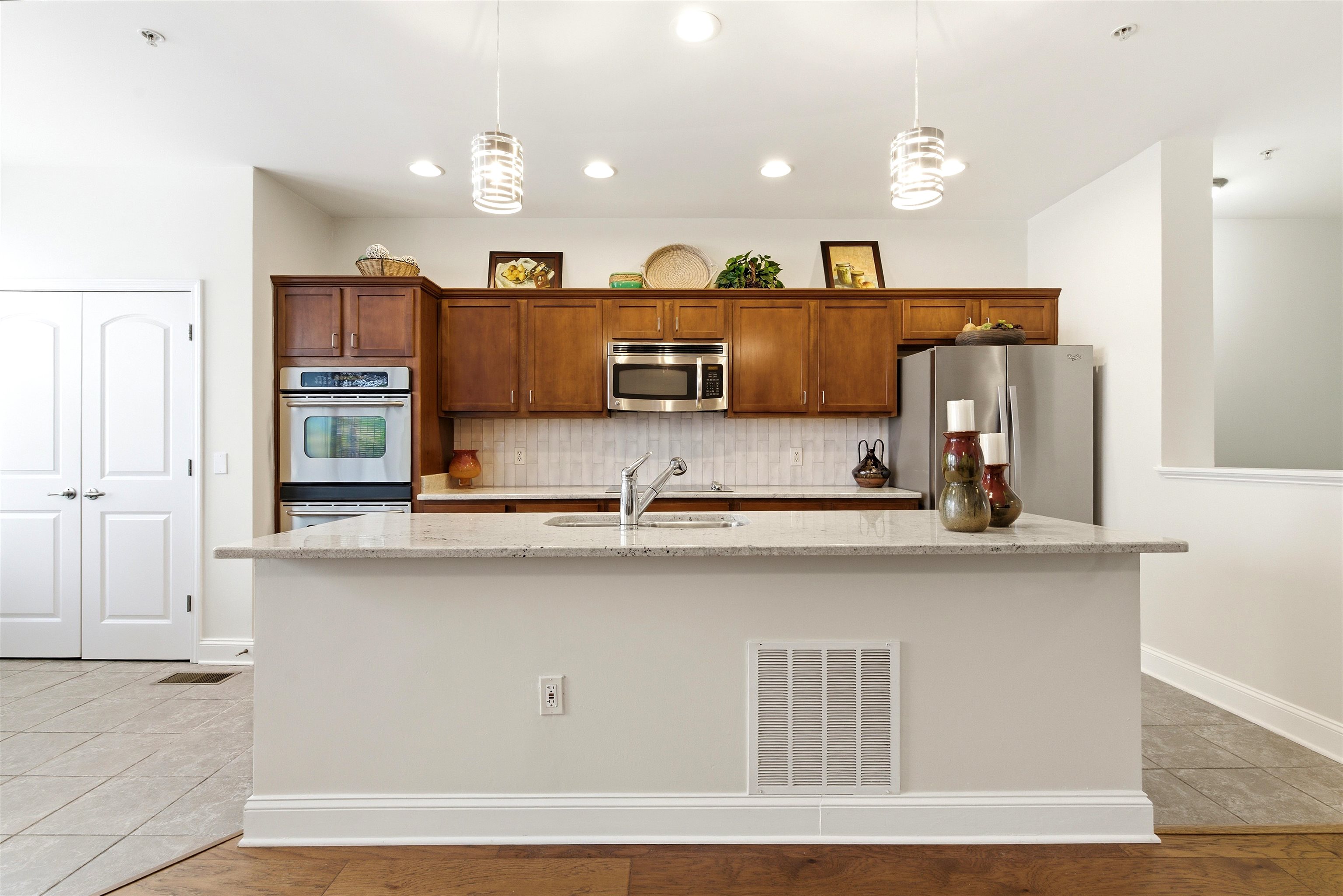 75 Shoemaker Court, Unit 105 Memphis, TN 38103 - Photo 28 of 36 a kitchen with stainless steel appliances granite countertop a sink a microwave counter space and cabinets
