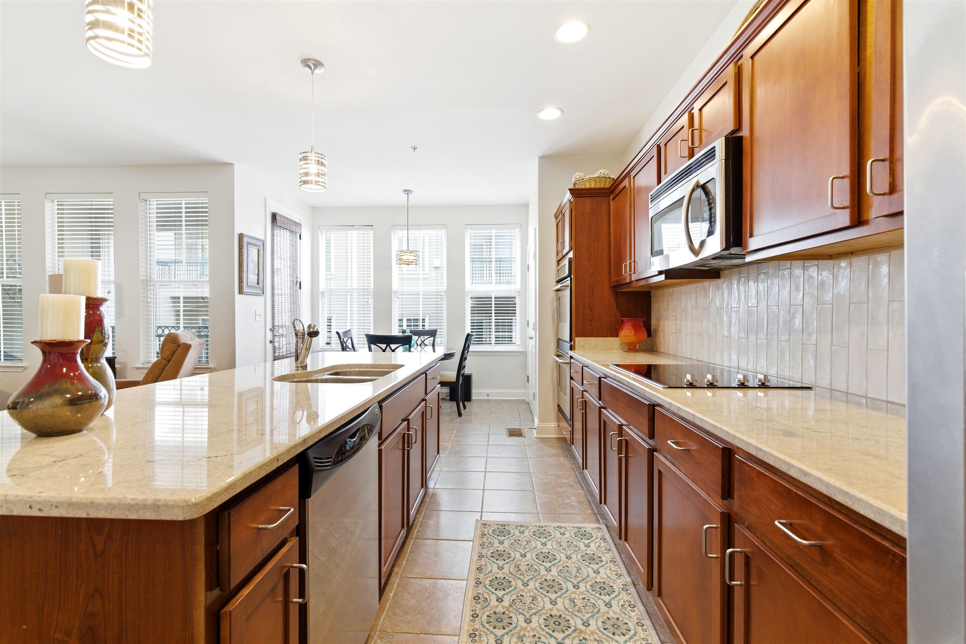 75 Shoemaker Court, Unit 105 Memphis, TN 38103 - Photo 30 of 36 a large kitchen with stainless steel appliances granite countertop a lot of counter space and a sink