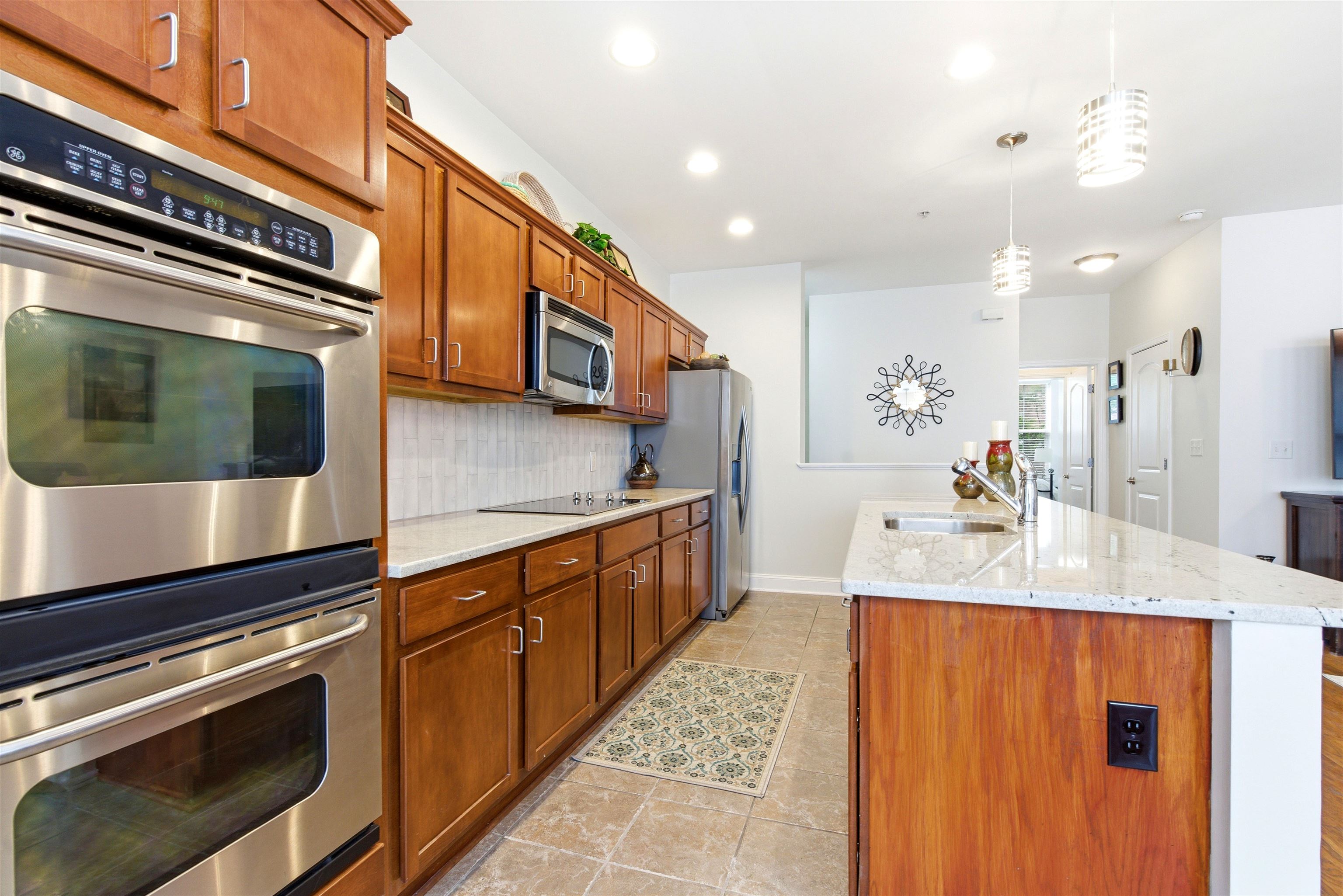 75 Shoemaker Court, Unit 105 Memphis, TN 38103 - Photo 32 of 36 a kitchen with stainless steel appliances granite countertop a sink and a stove top oven