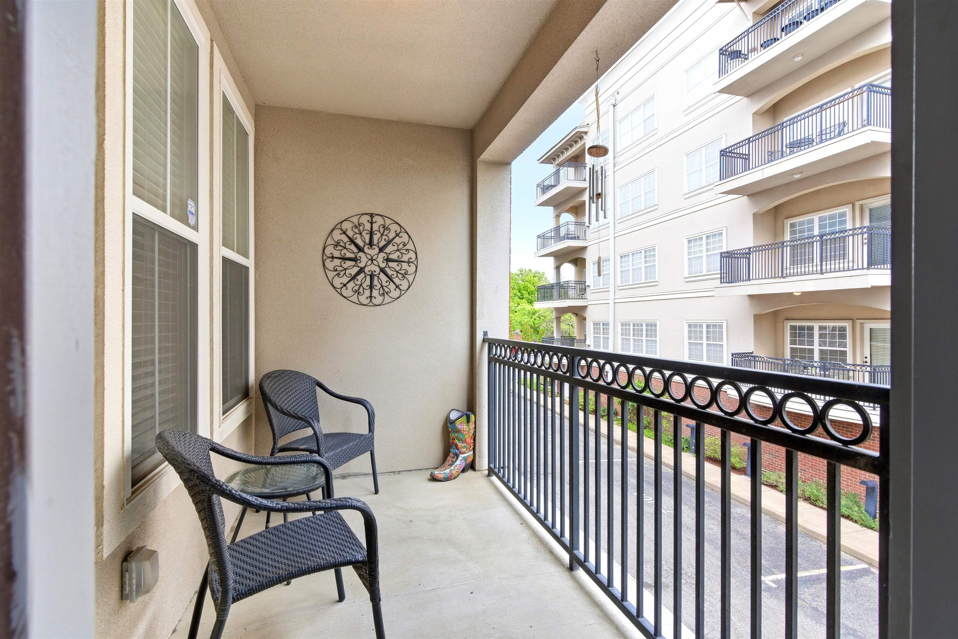 75 Shoemaker Court, Unit 105 Memphis, TN 38103 - Photo 33 of 36 a view of a chairs and a table in the balcony