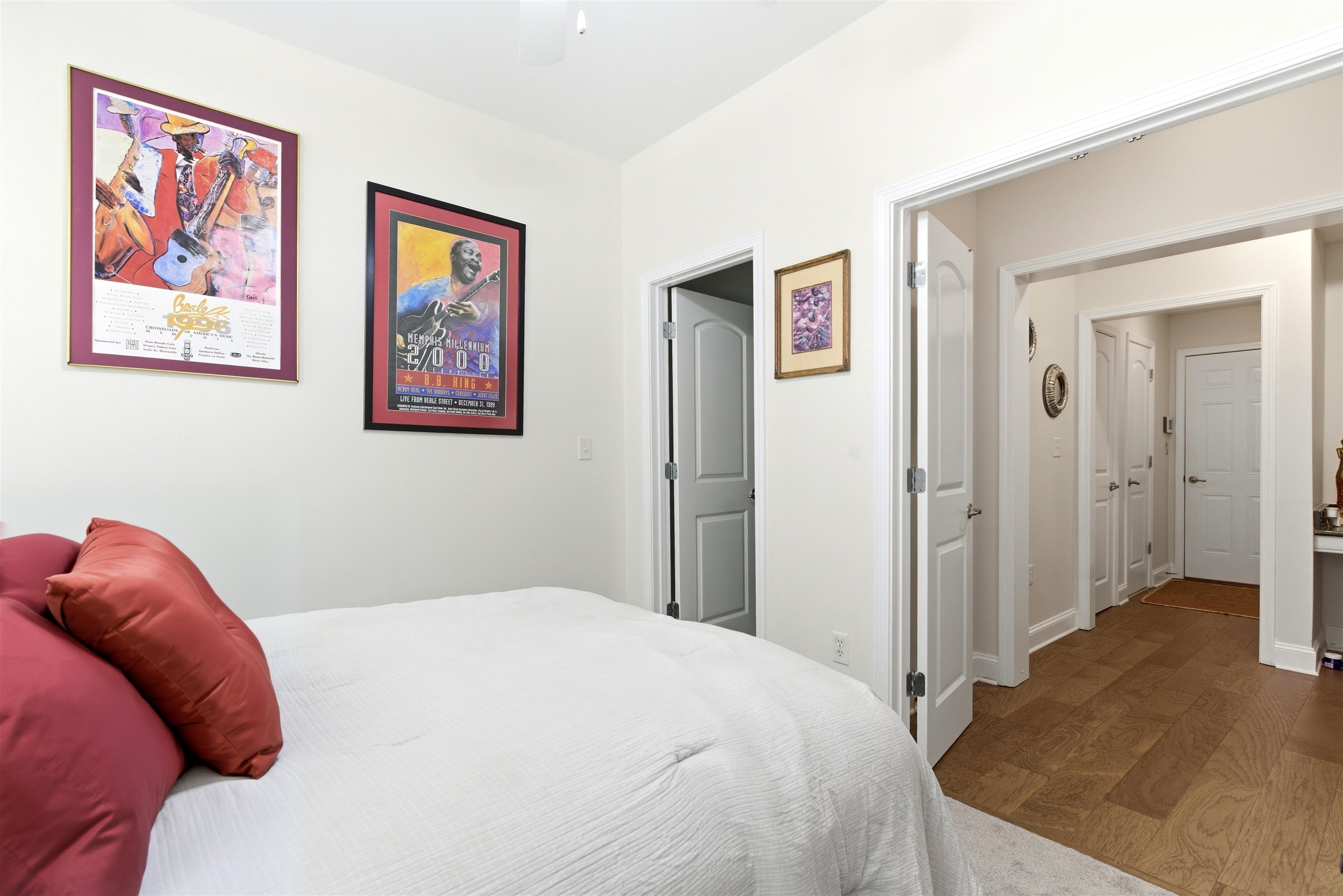 75 Shoemaker Court, Unit 105 Memphis, TN 38103 - Photo 7 of 36 a bedroom with a bed and a painting on the wall