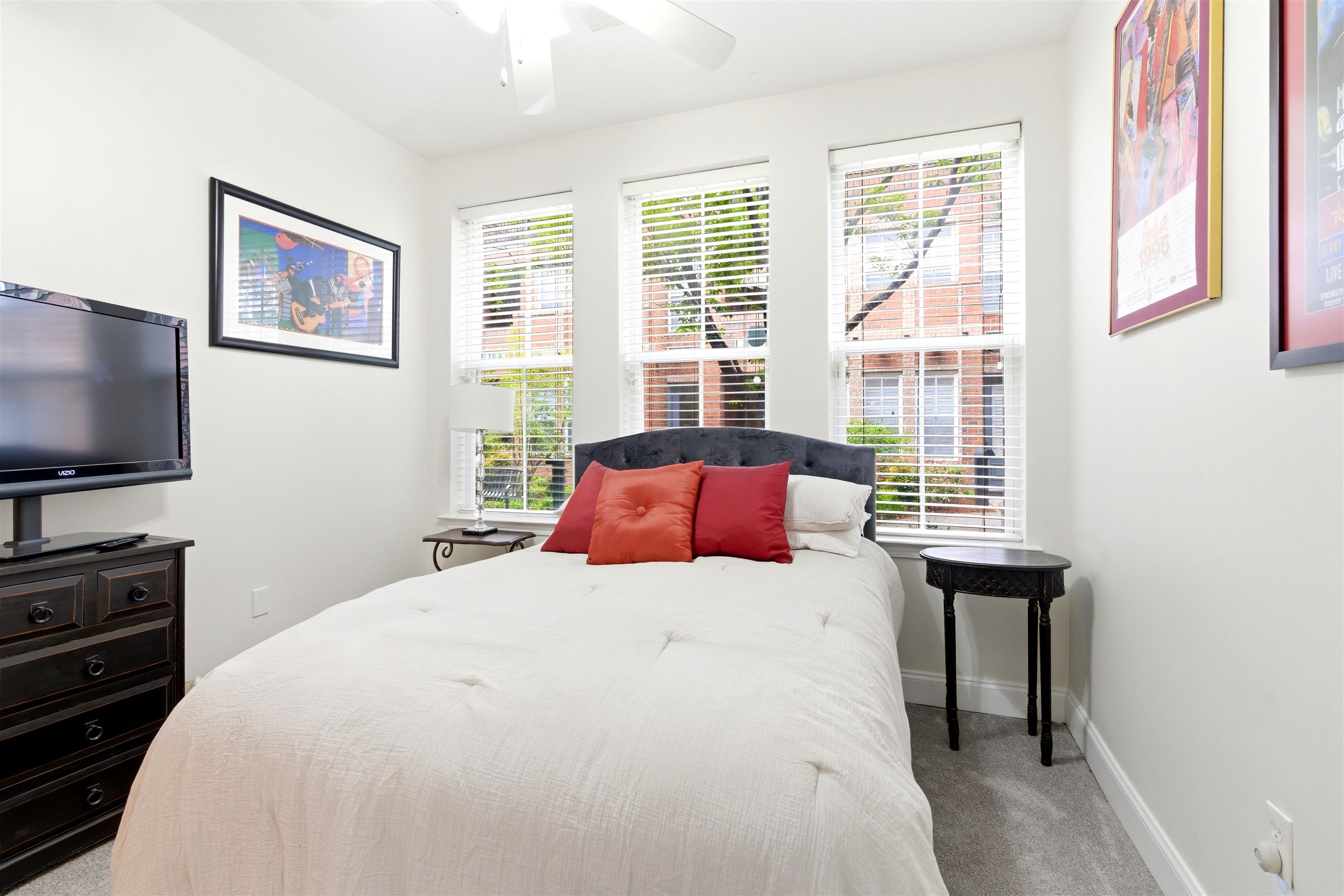 75 Shoemaker Court, Unit 105 Memphis, TN 38103 - Photo 8 of 36 a bedroom with a bed and a flat screen tv