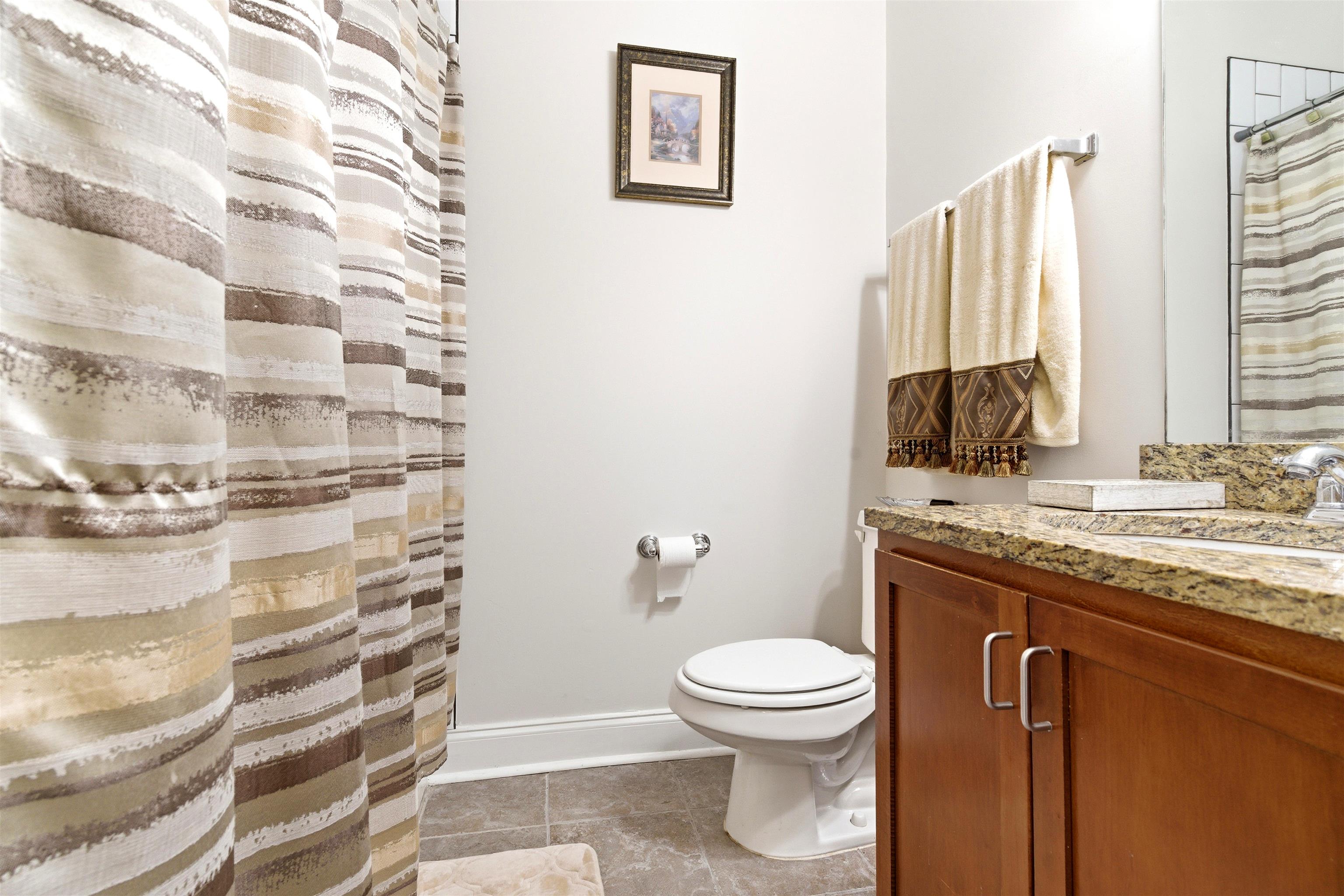 75 Shoemaker Court, Unit 105 Memphis, TN 38103 - Photo 10 of 36 a bathroom with a granite countertop sink toilet and shower