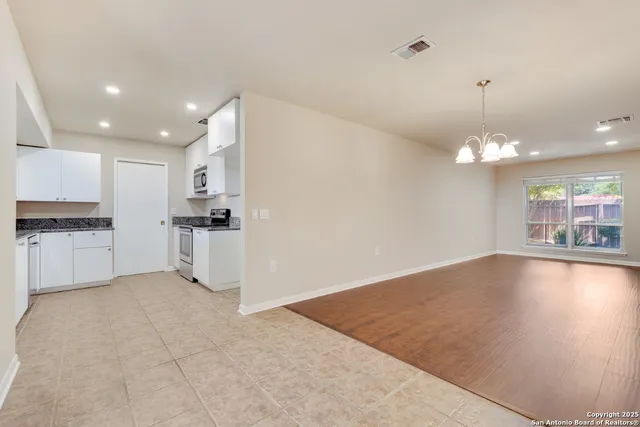 a view of a kitchen with a sink and a refrigerator