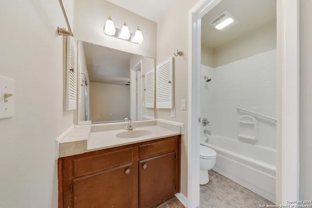 a bathroom with a sink double vanity granite tub and shower