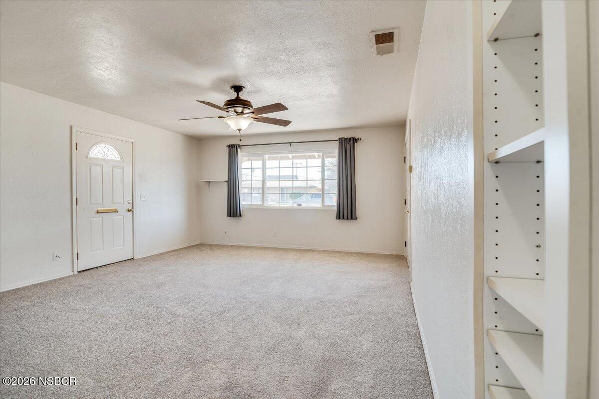533 North G Street Lompoc, CA 93436 - Photo 13 of 32 an empty room with windows and ceiling fan