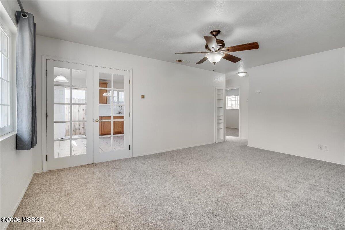 533 North G Street Lompoc, CA 93436 - Photo 14 of 32 an empty room with chandelier fan and windows