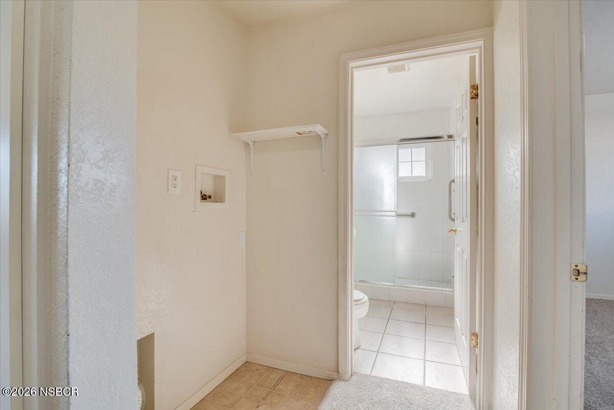 533 North G Street Lompoc, CA 93436 - Photo 19 of 32 a bathroom with a glass shower door