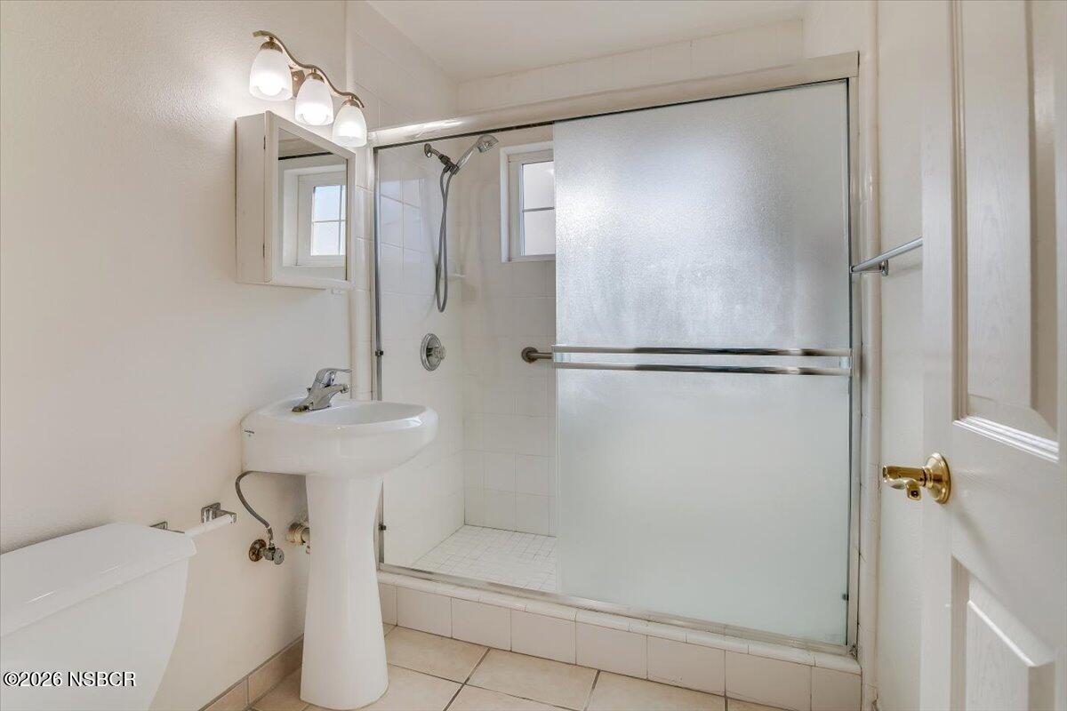 533 North G Street Lompoc, CA 93436 - Photo 20 of 32 a bathroom with a shower and a sink