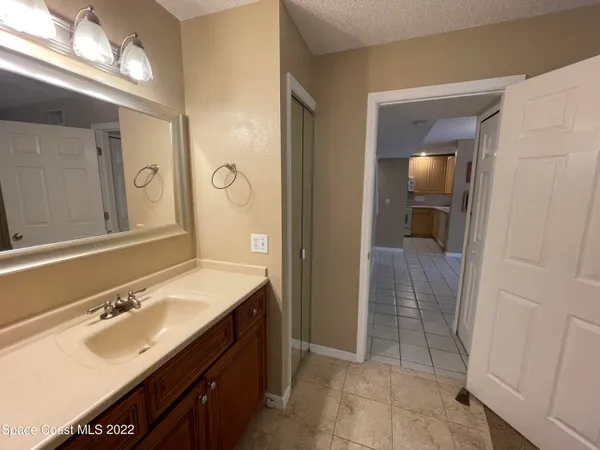 a spacious bathroom with a mirror sink and shower