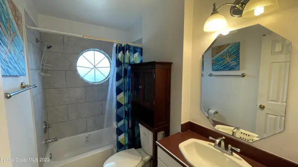 a bedroom with a bed and lamp